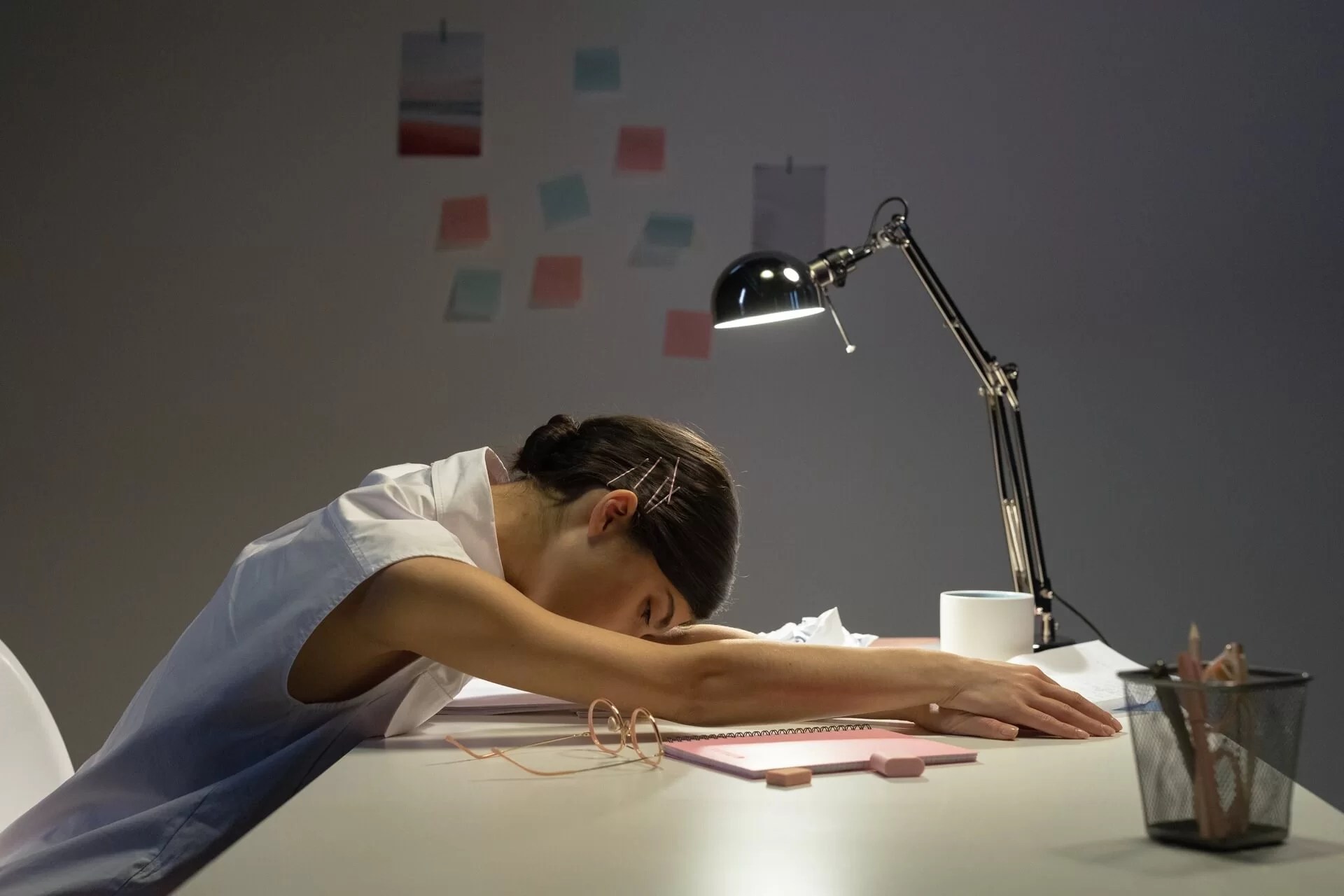 tired employee resting her head on the desk